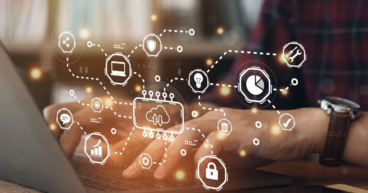 Hände auf der Tastatur eines Notebooks, davor ein symbolisiert ein interaktives Dashboard mit Icons, die Anwendungsfälle von Cloud Computing symbolisieren