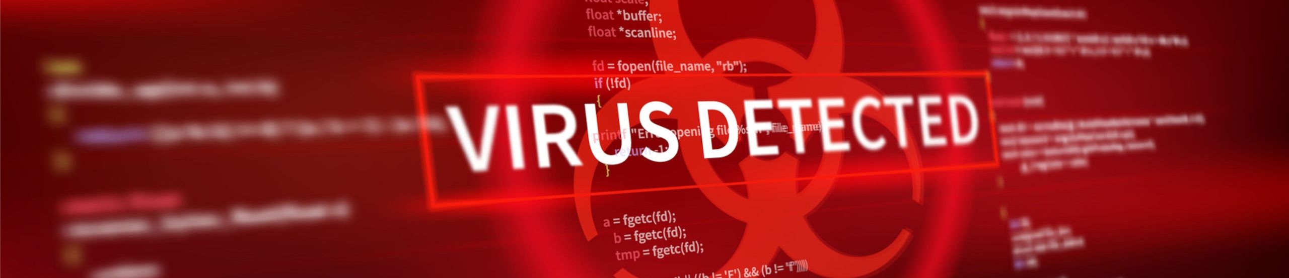 Screenshot mit Programmcode als Bildhintergrund und dem Schriftzug „VIRUS DETECTED“ in der Mitte des Bildes.